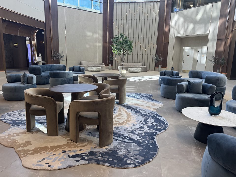 Lounge chairs and a blue rug in the lobby