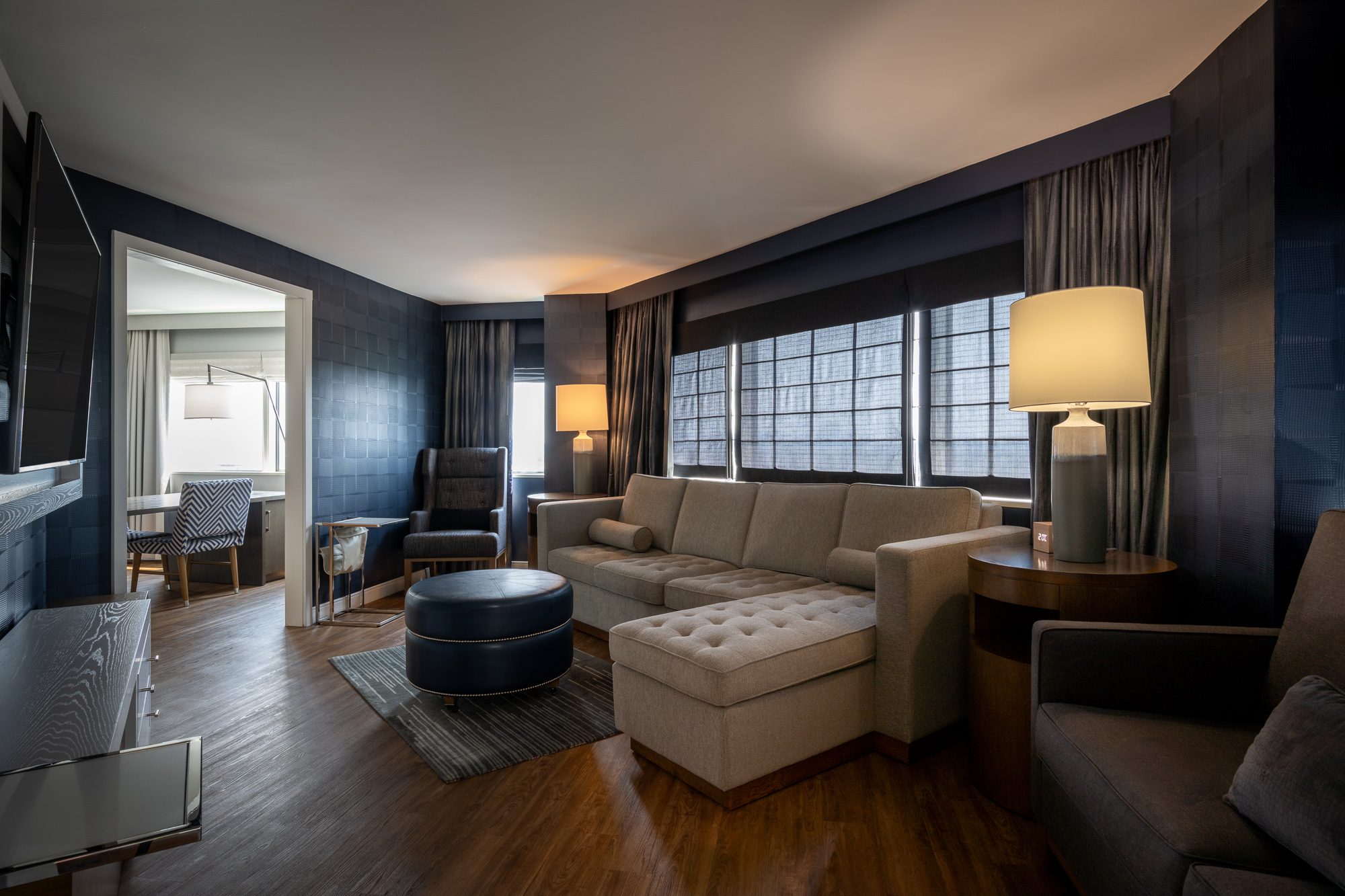 The Parlor Room lounge with a sectional sofa and dining area