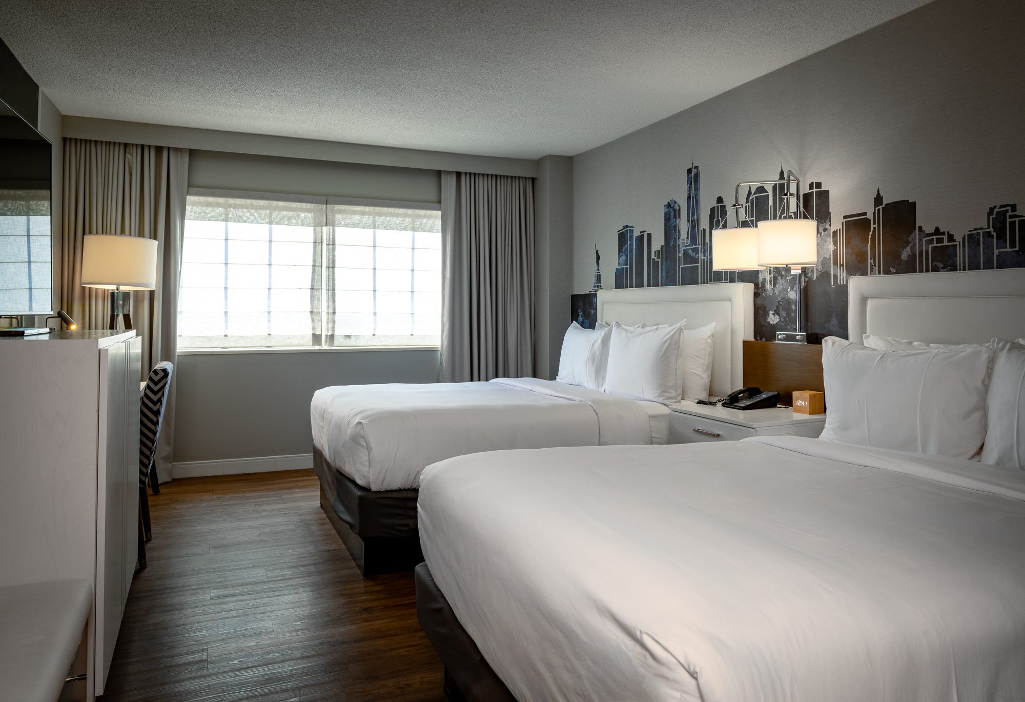 A Blue View room with two queen beds and the skyline mural